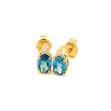 Aretes de topacio azul con diamantes en oro amarillo 14kt.