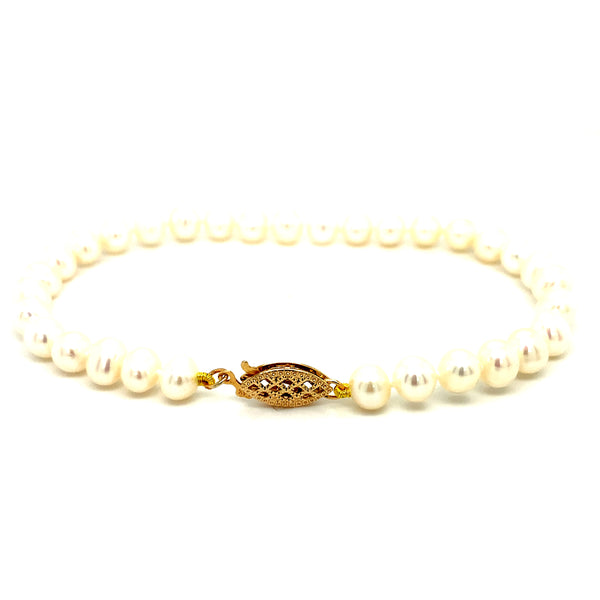 Pulsera de perlas blancas en oro amarillo 14kt. 19cm